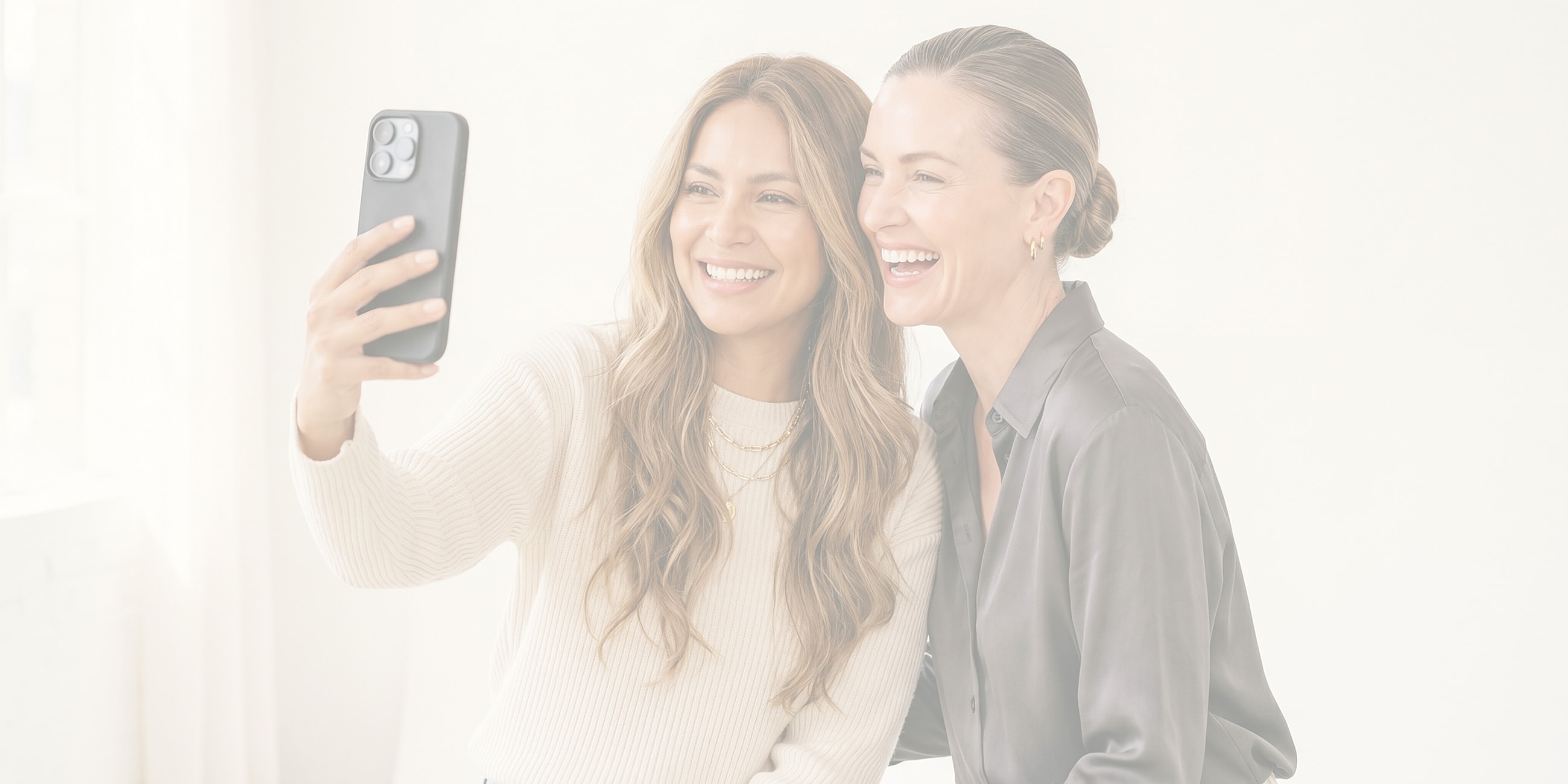 Friends taking a selfie together, smiling.