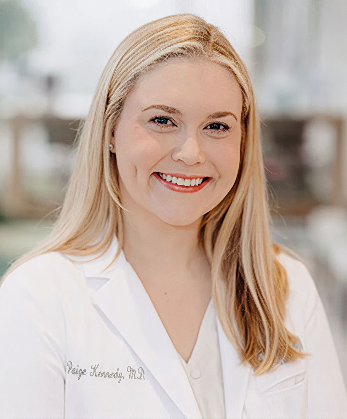 Smiling doctor in a white coat smiling.