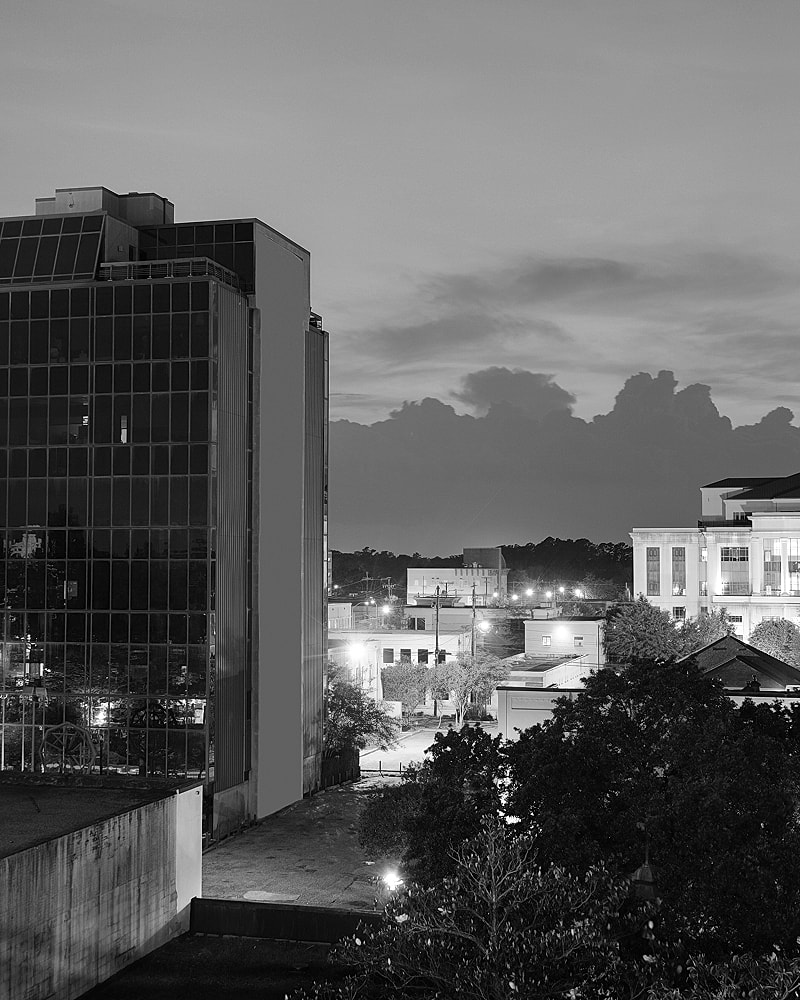 Black and white cityscape at dusk.