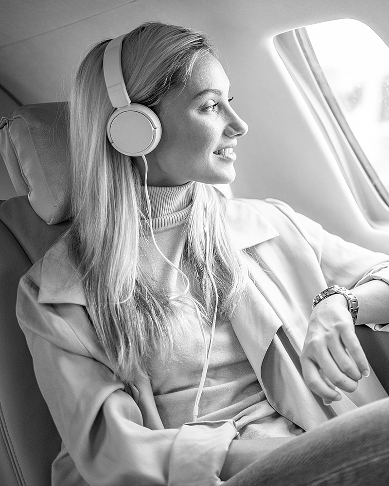 Woman with headphones enjoying a flight.