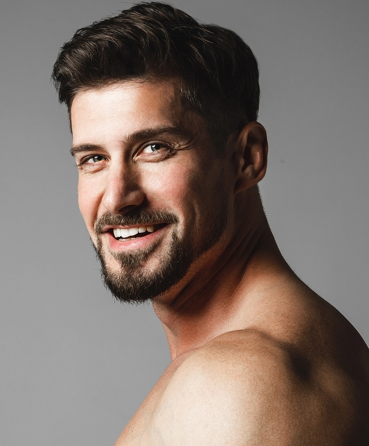 Smiling man with short hair and beard.