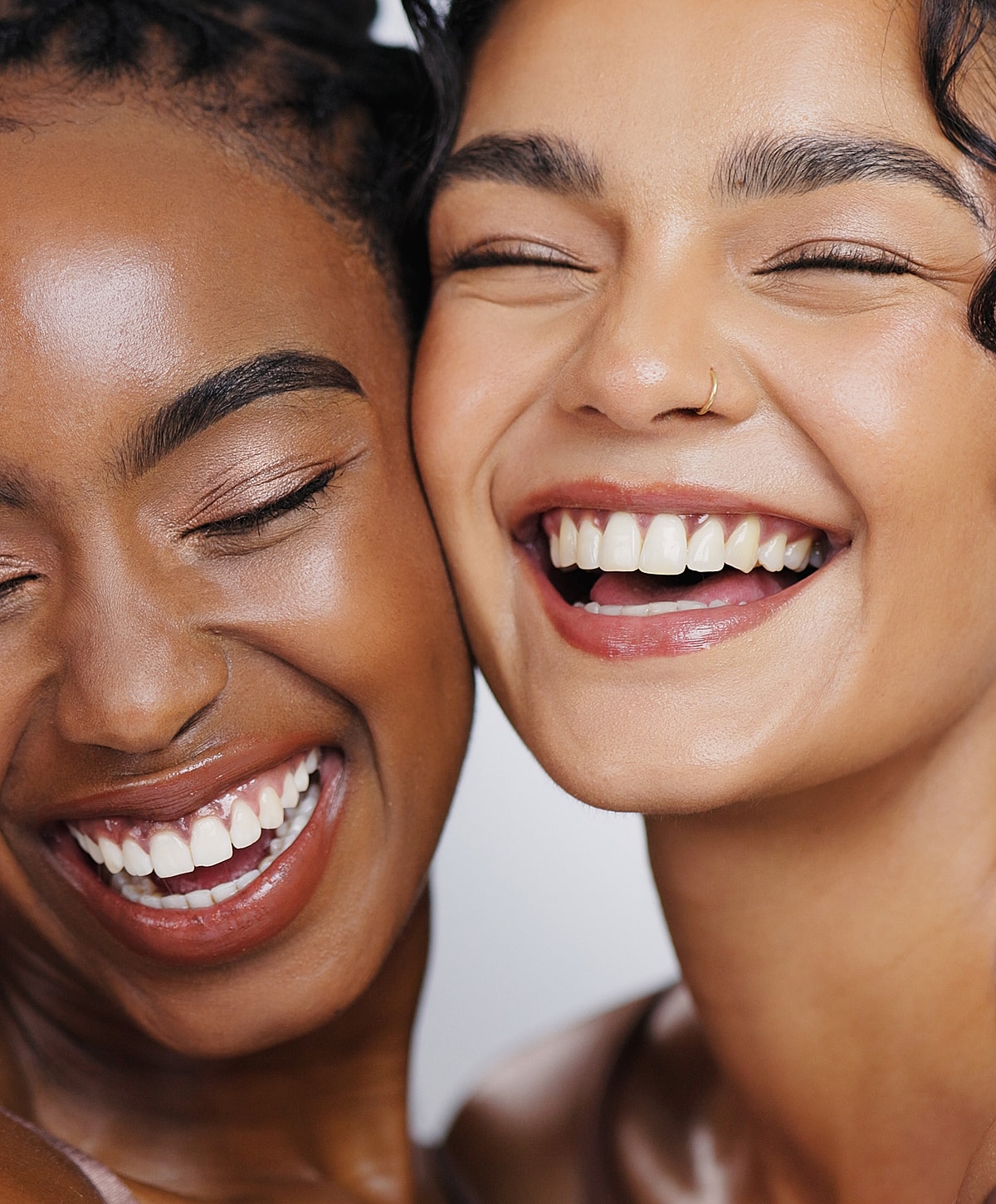 Two women smiling together, showcasing happiness.