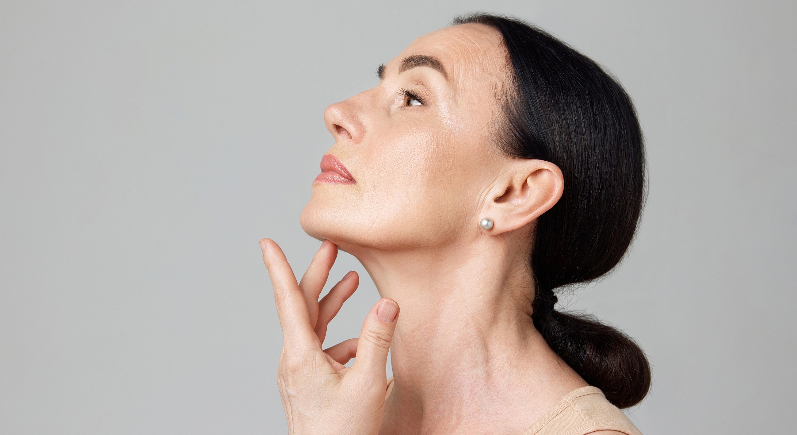 Woman touching her chin, profile view.
