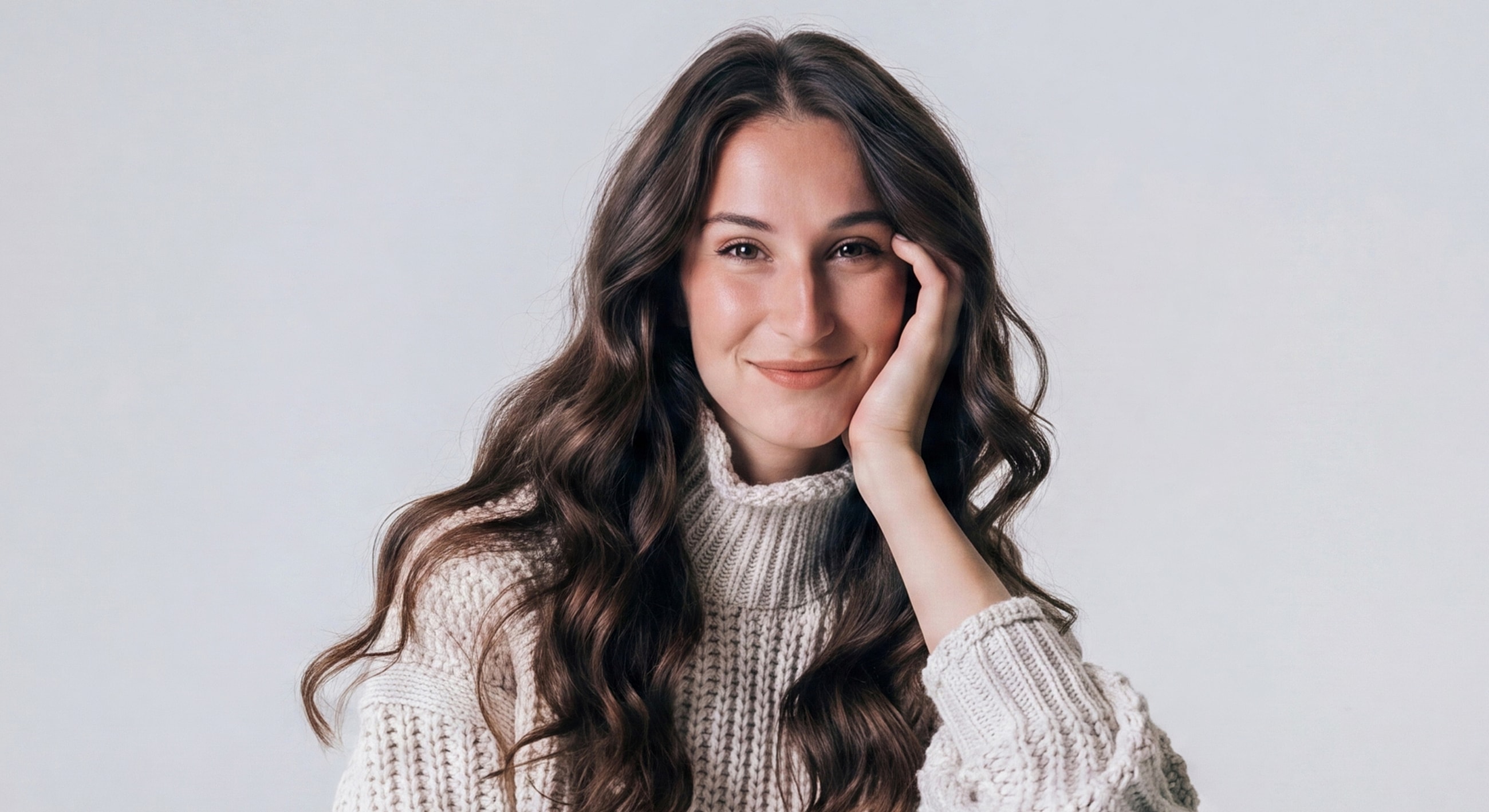 Smiling woman in a cozy sweater.