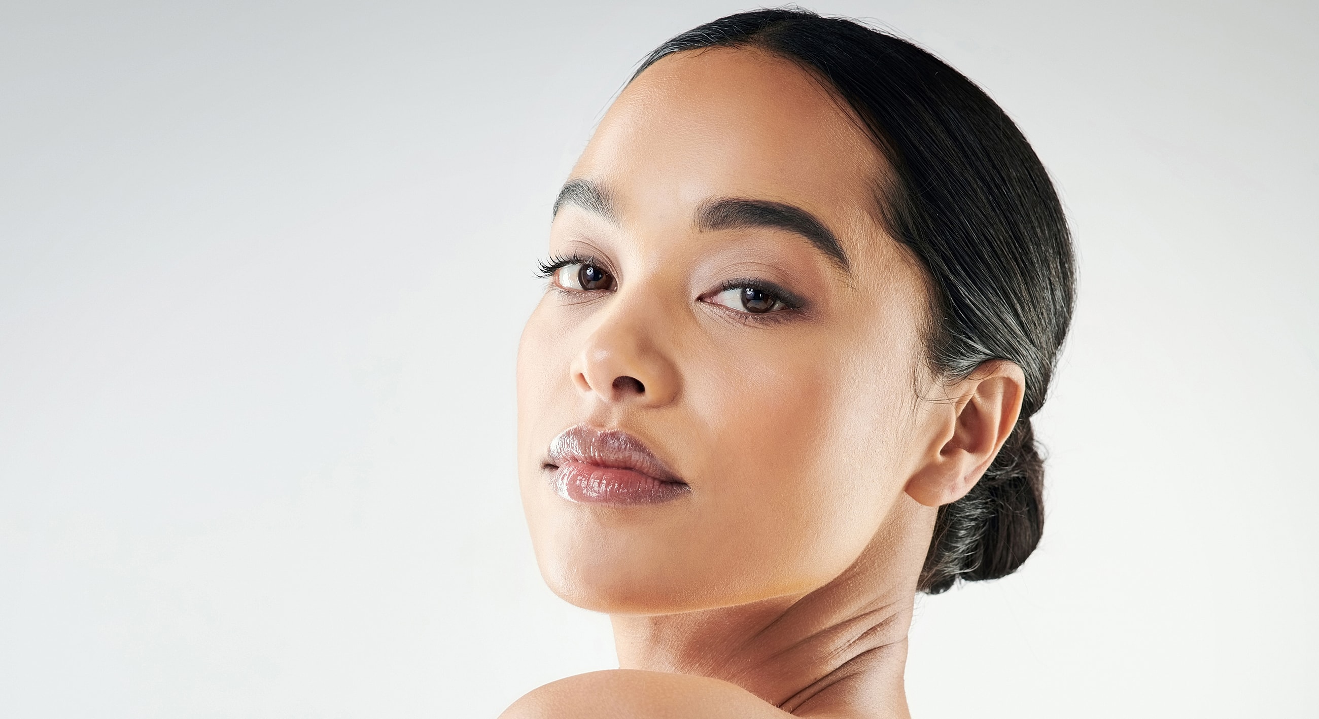 Woman with sleek hair and confident expression.