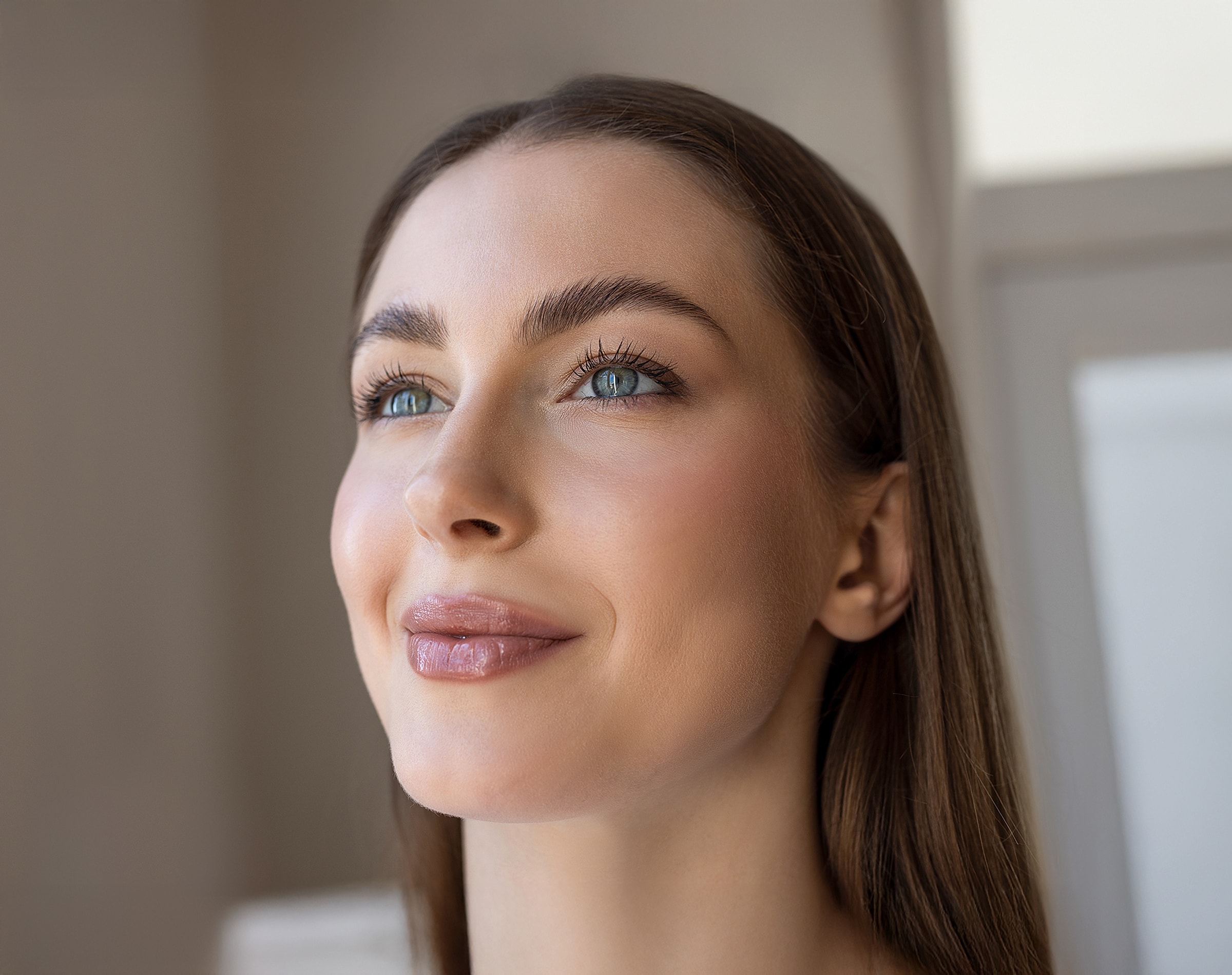 Smiling woman with long hair and bright eyes.