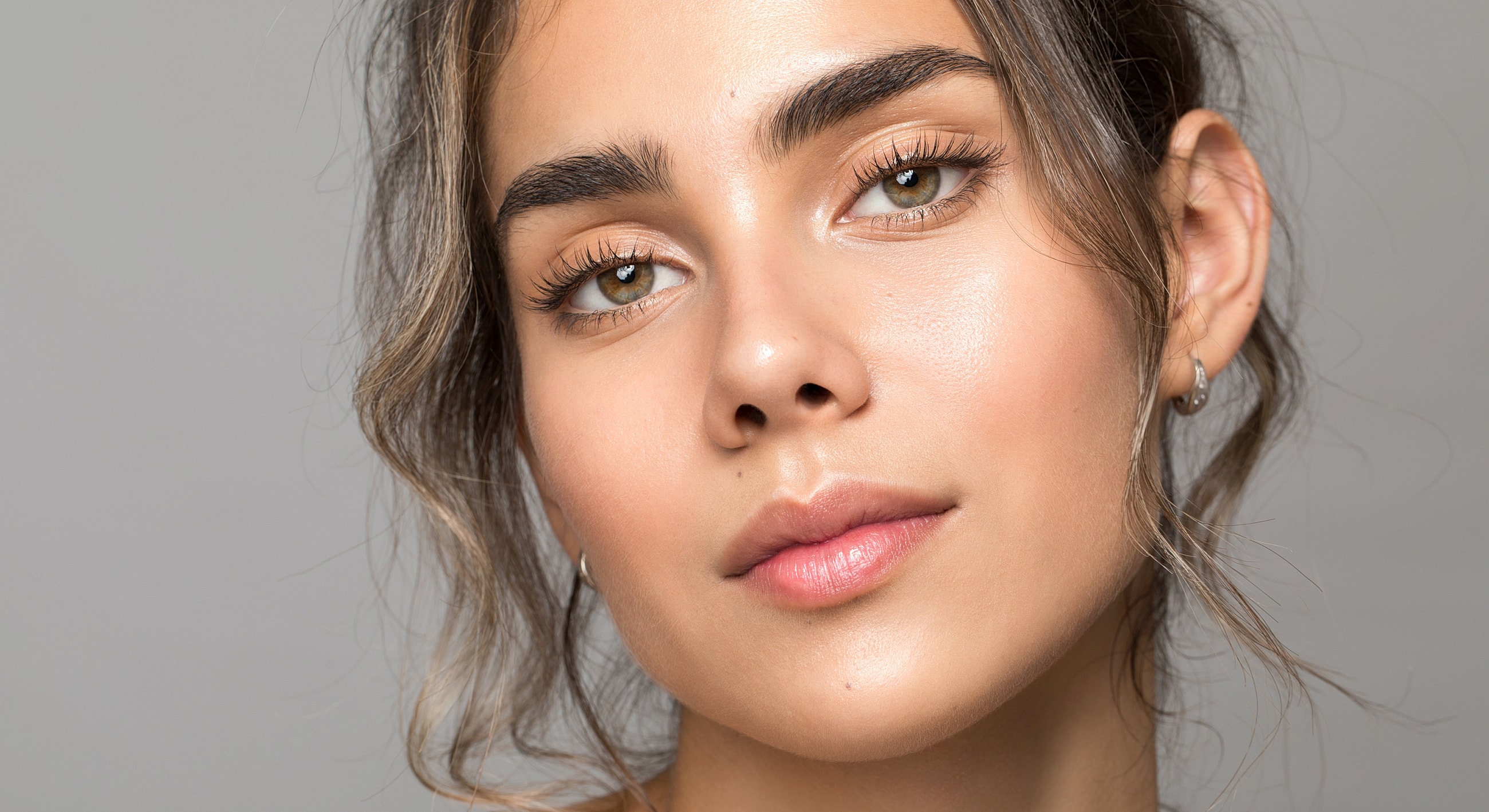 Close-up of a woman's face with natural makeup.